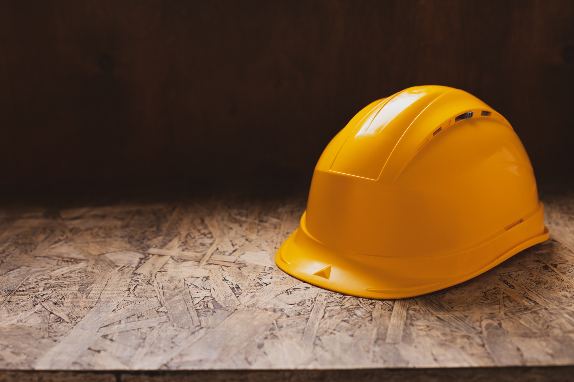 Construction helmet at wooden table background texture. Work cap and concept of renovation Construction helmet at wooden table background texture. Work cap and concept of renovation