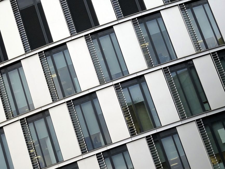 Angled view of a modern office building with large glass windows and steel accents.