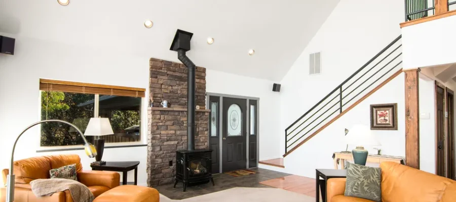 Bright and welcoming living room featuring a rustic fireplace and modern decor.