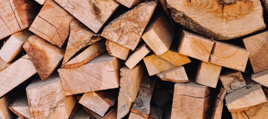 Close-up of a neatly stacked pile of chopped firewood, ideal for home heating or campfire fuel.