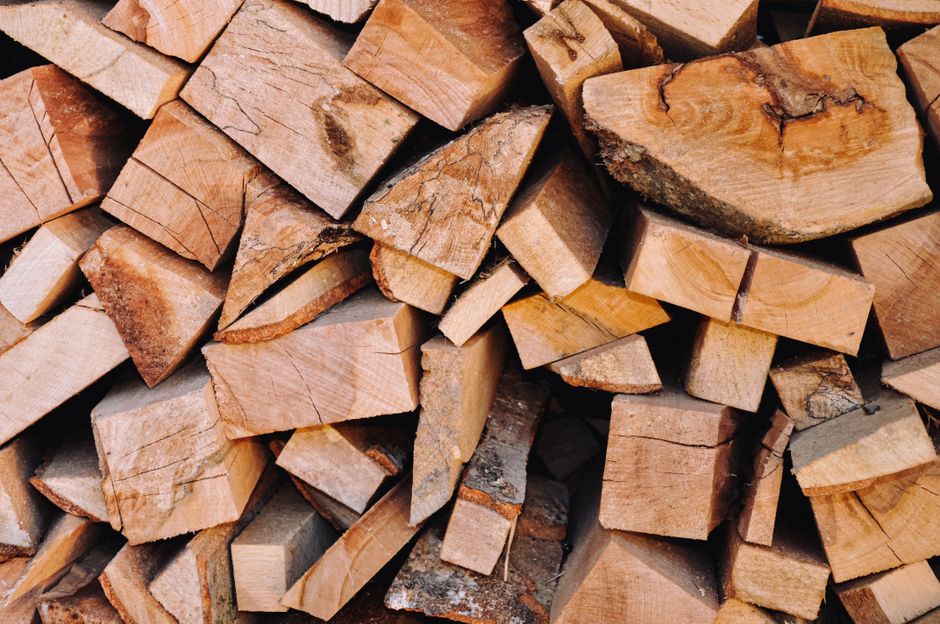 Close-up of a neatly stacked pile of chopped firewood, ideal for home heating or campfire fuel.