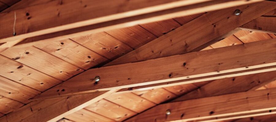 Close-up of a rustic wooden ceiling with exposed beams and natural wood texture.