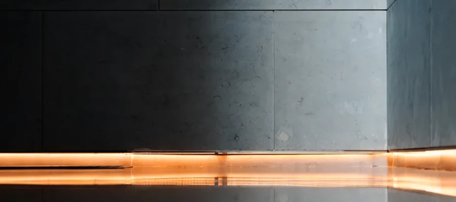 Modern interior showcasing sleek walls, reflective flooring, and ambient lighting for a serene atmosphere.
