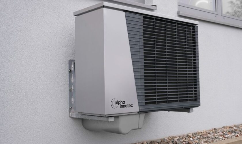Outdoor air conditioning unit mounted on a residential building exterior.