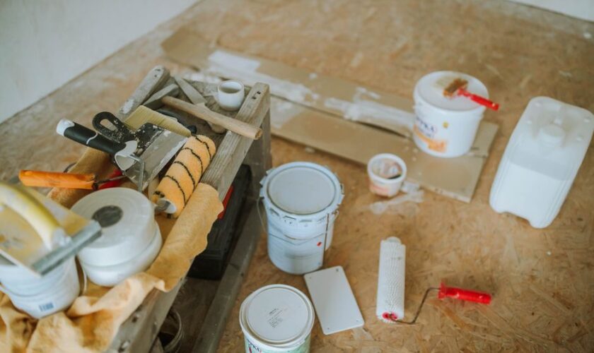 Overhead shot of tools and paint supplies for a home renovation project.