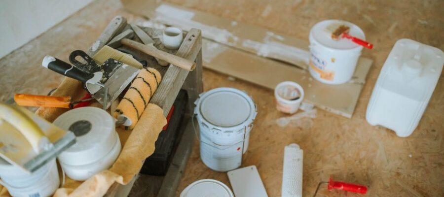 Overhead shot of tools and paint supplies for a home renovation project.