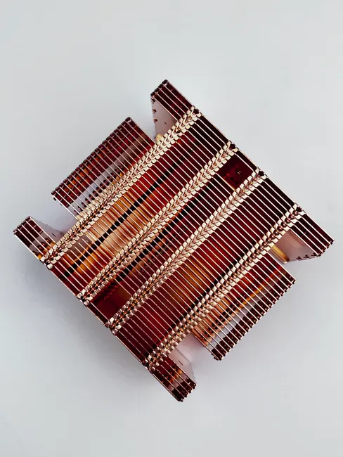 Top view of a copper radiator showcasing intricate electronic elements, photographed in Dongguan, China.