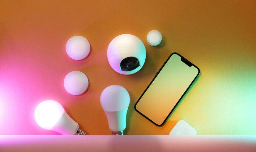 A collection of smart home devices including light bulbs and a smartphone, showcasing modern technology.
