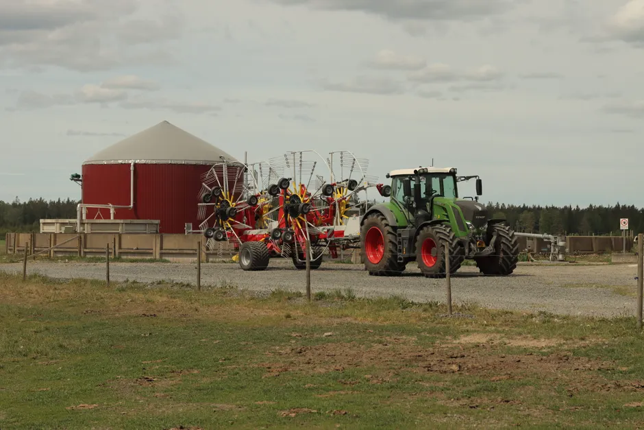 A modern tractor with rakes at a farm in Jönköping, Sweden captures the essence of contemporary agriculture.