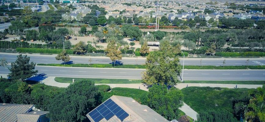 Aerial view showing suburban houses with solar panels, showcasing clean energy.