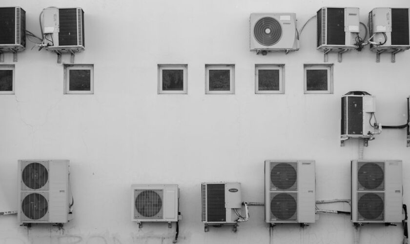 Black and white image of air conditioners mounted on a building facade in Córdoba, Argentina.