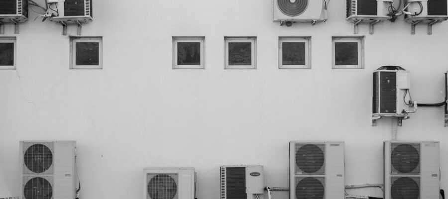 Black and white image of air conditioners mounted on a building facade in Córdoba, Argentina.