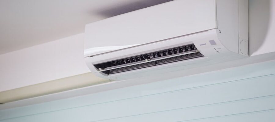 Close-up of a wall-mounted air conditioner indoors, showcasing sleek design for modern cooling solutions.