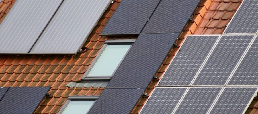 Close-up of solar panels on a tiled roof, showcasing sustainable energy solutions.