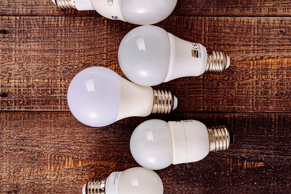Collection of LED light bulbs arranged on a rustic wooden background.