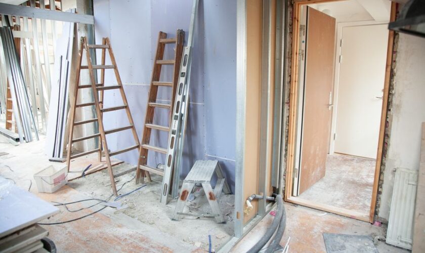 Construction site featuring ladders and tools in a home renovation setting.