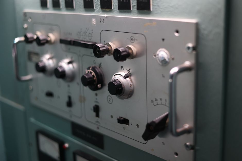 Detailed view of switches and dials on an industrial control panel, showcasing engineering complexity.