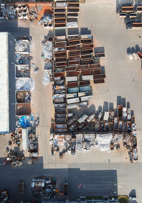 Drone shot of a recycling yard in Regensburg, Germany with containers and sorted materials.