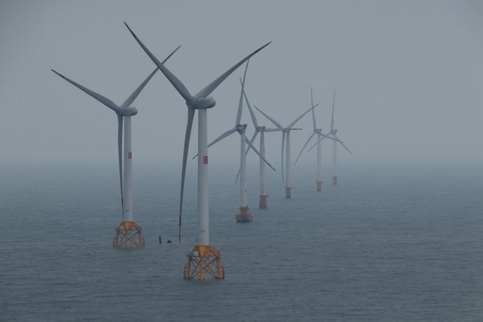 Offshore wind turbines generating clean energy in the ocean breeze.