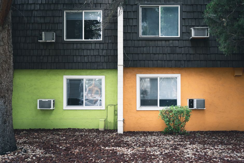Vibrant split-color apartment facade with air conditioners in Boise, Idaho.