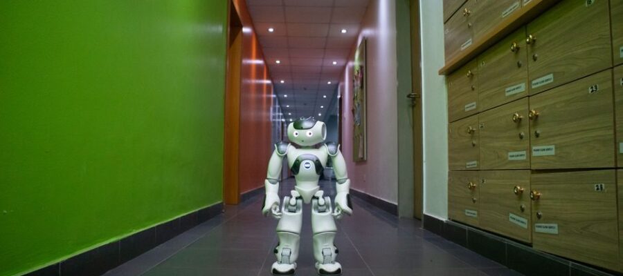A humanoid robot stands in a vibrant, modern hallway in Lagos, Nigeria.