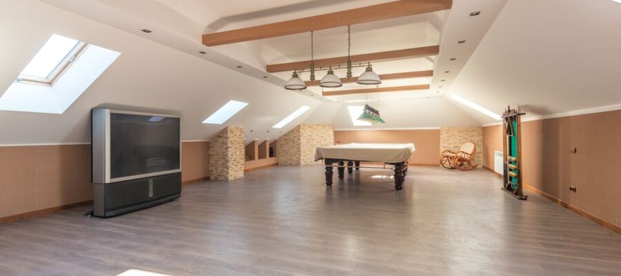 Bright attic space featuring a sleek pool table and skylights, perfect for leisure.