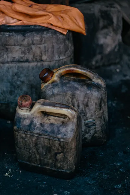 Close-up of dirty fuel canisters in a workshop in Denizli, Türkiye.