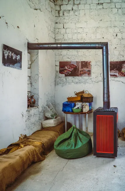 Cozy interior of a rustic room in Kakheti, Georgia with a stove and decor items.