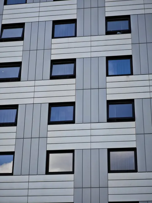 Detailed view of a modern building facade with geometric window patterns.