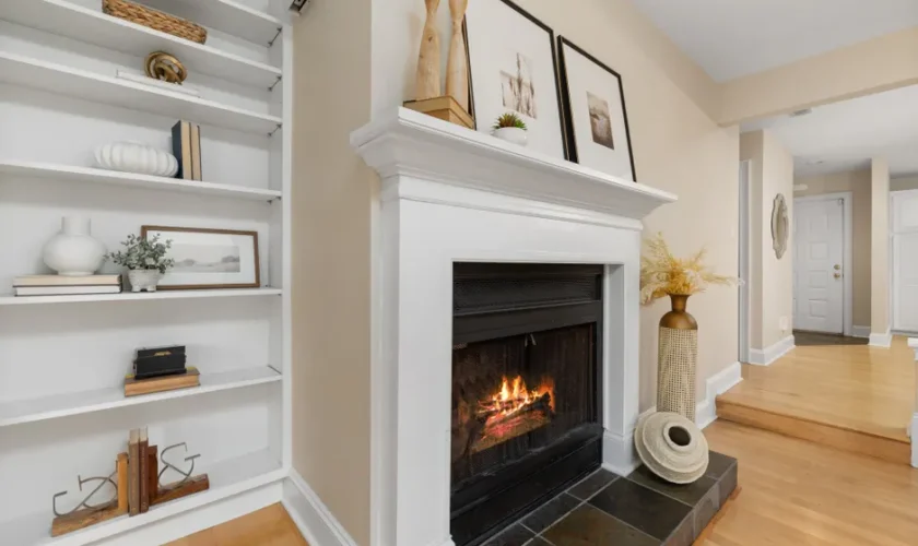 Elegant living room interior featuring a lit fireplace and decorative shelving.