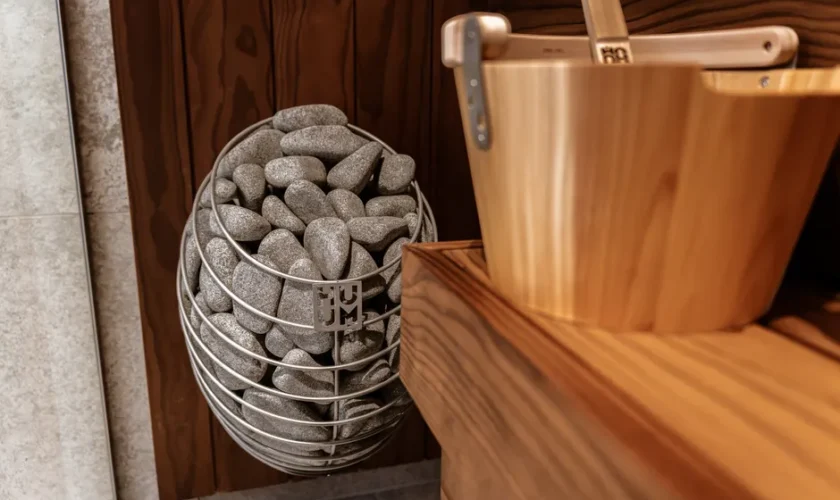 Explore the elegance of a modern indoor sauna featuring a Huum electric heater and sleek wooden panels.