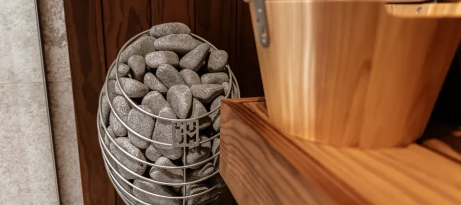 Explore the elegance of a modern indoor sauna featuring a Huum electric heater and sleek wooden panels.