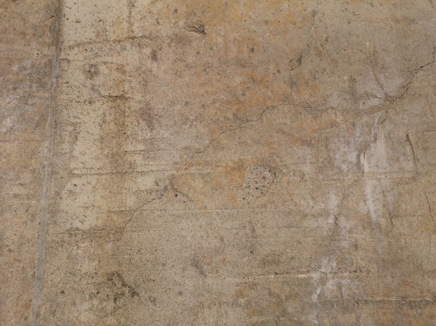 High-resolution image of a weathered concrete wall with rich texture details.