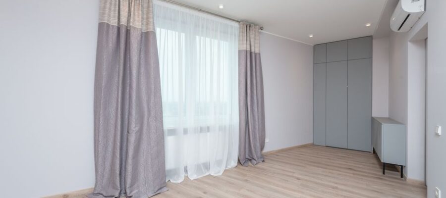 Modern room interior with cabinet and closet on floor under air conditioning and lamps in light house