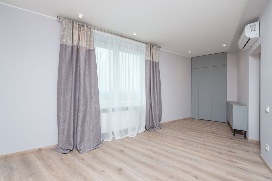 Modern room interior with cabinet and closet on floor under air conditioning and lamps in light house