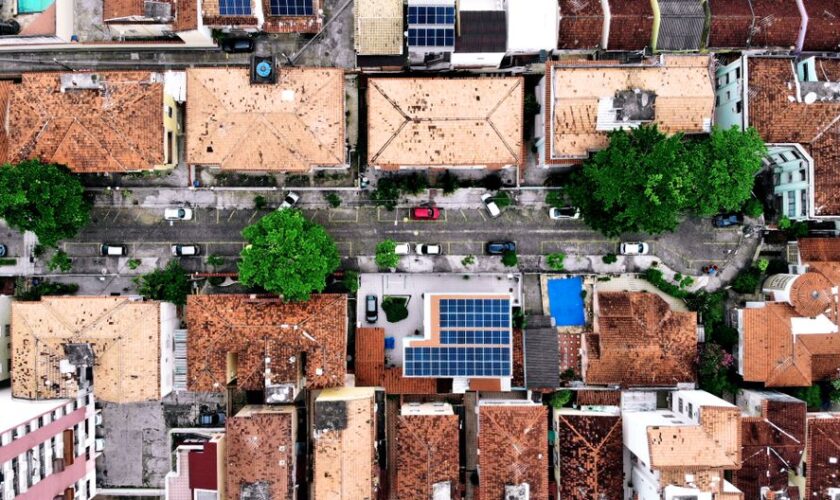 Top-down aerial shot of residential area with solar panels in Rio de Janeiro, Brazil.