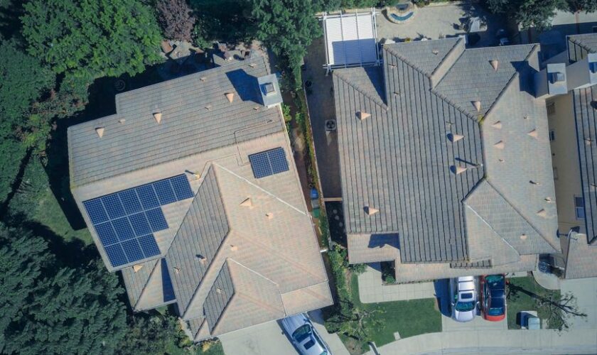 Top view of houses with solar panels, showcasing clean energy and sustainability.