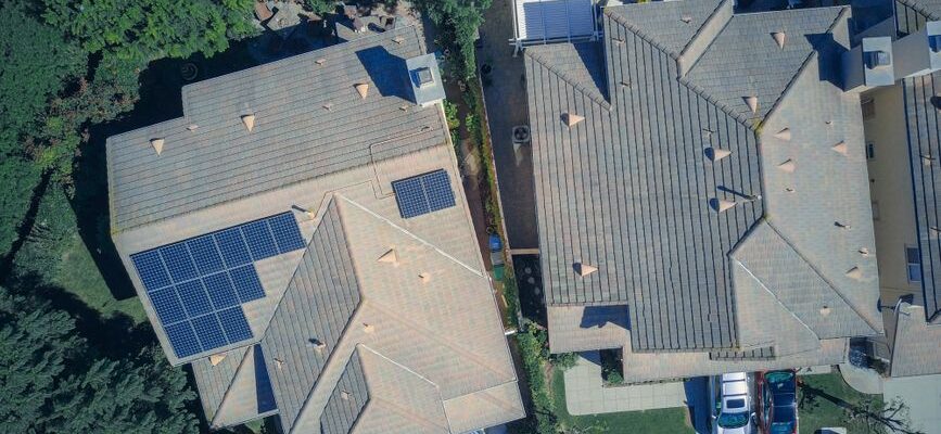 Top view of houses with solar panels, showcasing clean energy and sustainability.