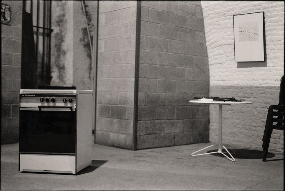 Vintage kitchen stove in a minimalist black and white interior setting.