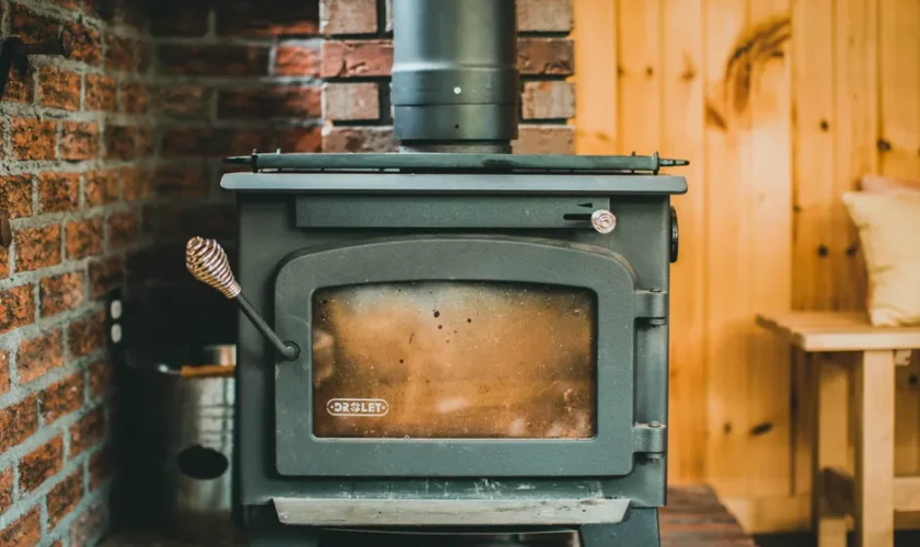 Warm indoor scene with a classic wood stove in a rustic cabin setting, ideal for cozy retreats.