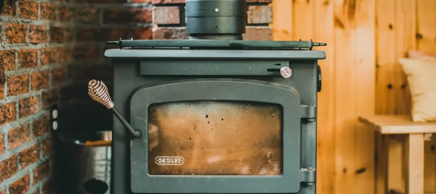 Warm indoor scene with a classic wood stove in a rustic cabin setting, ideal for cozy retreats.