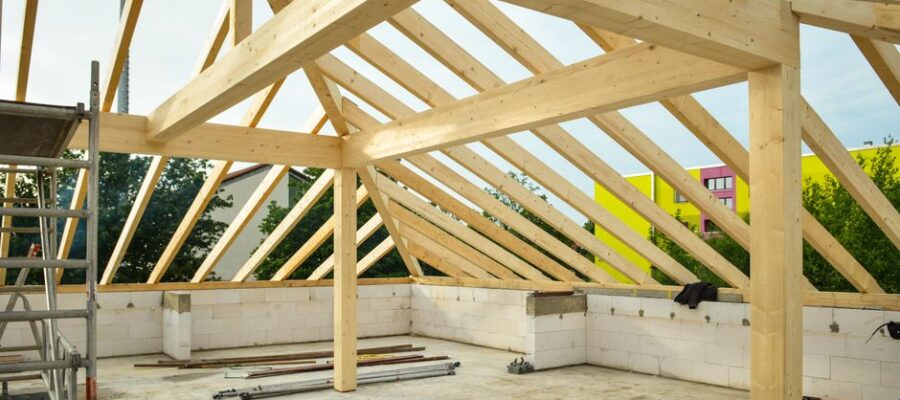Wooden roof structure in progress with open sky view, ideal for construction themes.